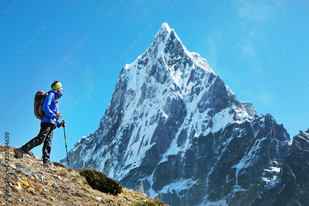Hiker with backpacks in Himalayas mountain, Nepal. Active sport concept.