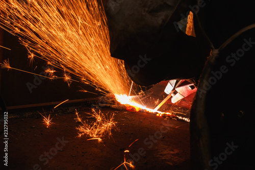 Photos Sparks and smoke from Welder arc Gouging carbon electrode rods  with equipment a