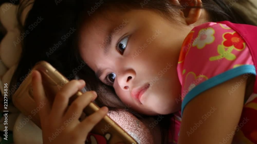 Thai child playing smartphone
Thai child playing smartphone