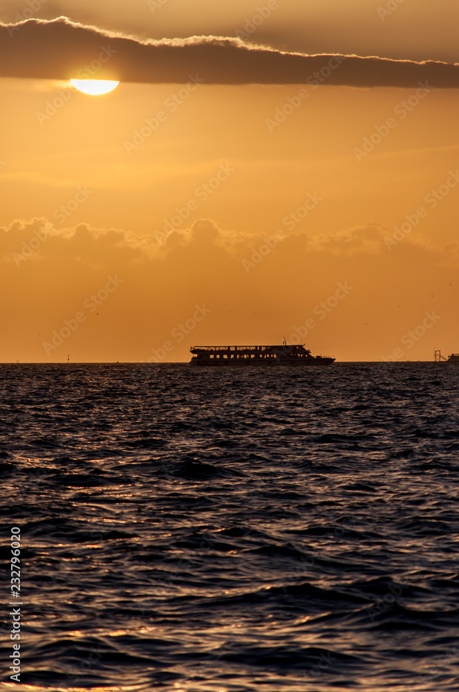 Ship at sea on a background of sunset sky. Izmir/Turkey