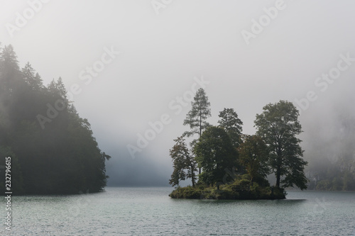wooded island on the lake in the clouds © passsy