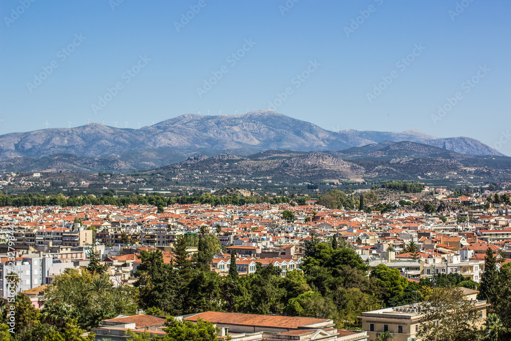 south city panorama and many buildings with orange shingles roofs on background of mountain horizon landscape 