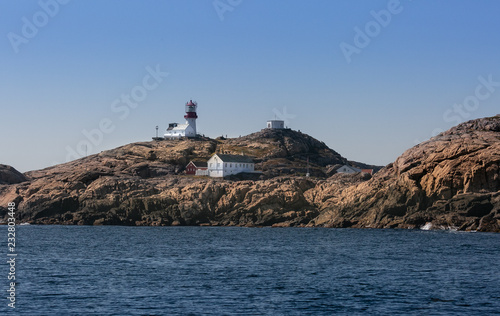 Navigation at sea. Lighthouse on a cliff. Norway. North Sea archipelago