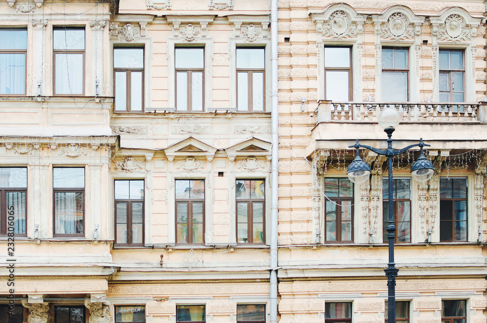 Saint Petersburg, RUSSIA - July 08, 2018: Fragment of a building facade with windows. Beautiful architecture of the city of St. Petersburg, Russia.