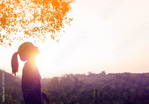 Young beautiful woman relaxing in summer sunrise sky outdoor. People freedom and relaxing in morning fresh air. photo