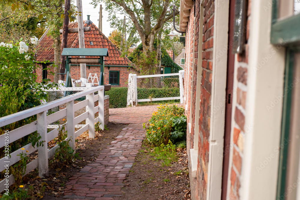 View on traditional Dutch houses and streets in a recreated heritage museum with beautiful historic vintage scenes from Holland. View on traditional Dutch houses and streets in a recreated heritage museum with beautiful historic vintage scenes from Holland.