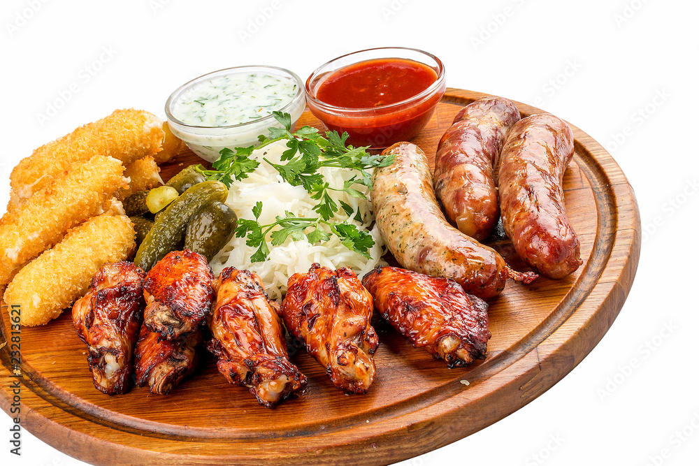 Assorted beer snacks. Cheese sticks, pickled cucumbers, grilled sausages, sauerkraut, chicken wings. Assorted beer snacks. Cheese sticks, pickled cucumbers, grilled sausages, sauerkraut, chicken wings.