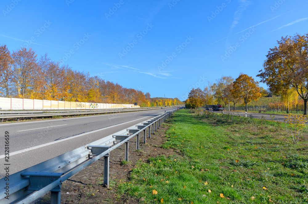 Freeway with crash barrier in autumn