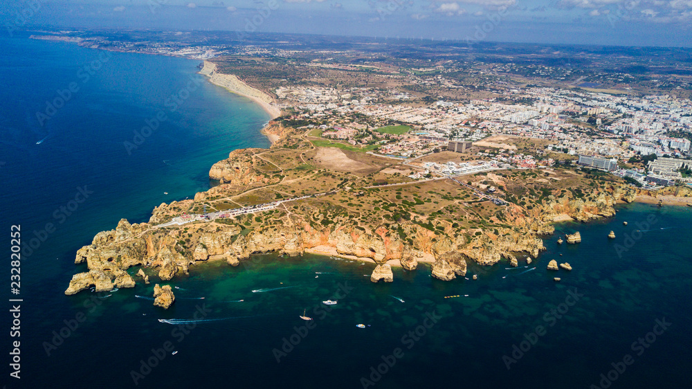 Aerial view of Ponta da Piedade of Lagos, Portugal. Beauty landscape of rugged seaside cliffs and aqua ocean waters in the Algarve region of Portugal