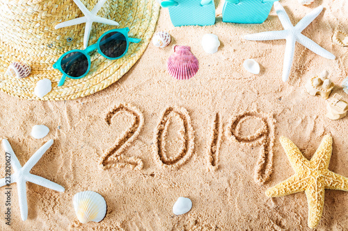2019 text in the sand with beach accessories