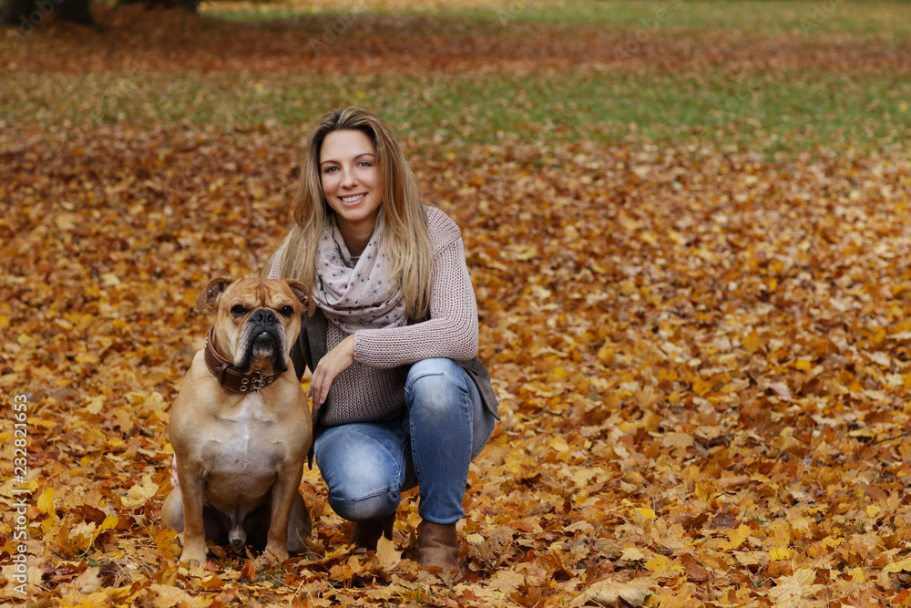 Middle age woman with her dog enjoying the autumnal nature Middle age woman with her dog enjoying the autumnal nature