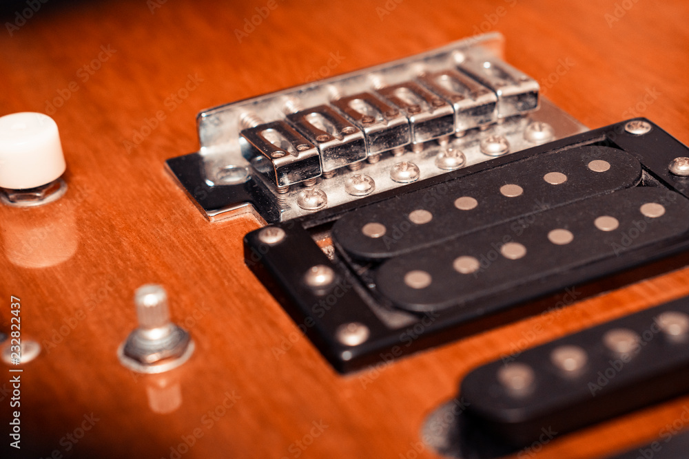 Fragment of an electric guitar with pickups. Strings are missing. Fragment of an electric guitar with pickups. Strings are missing.