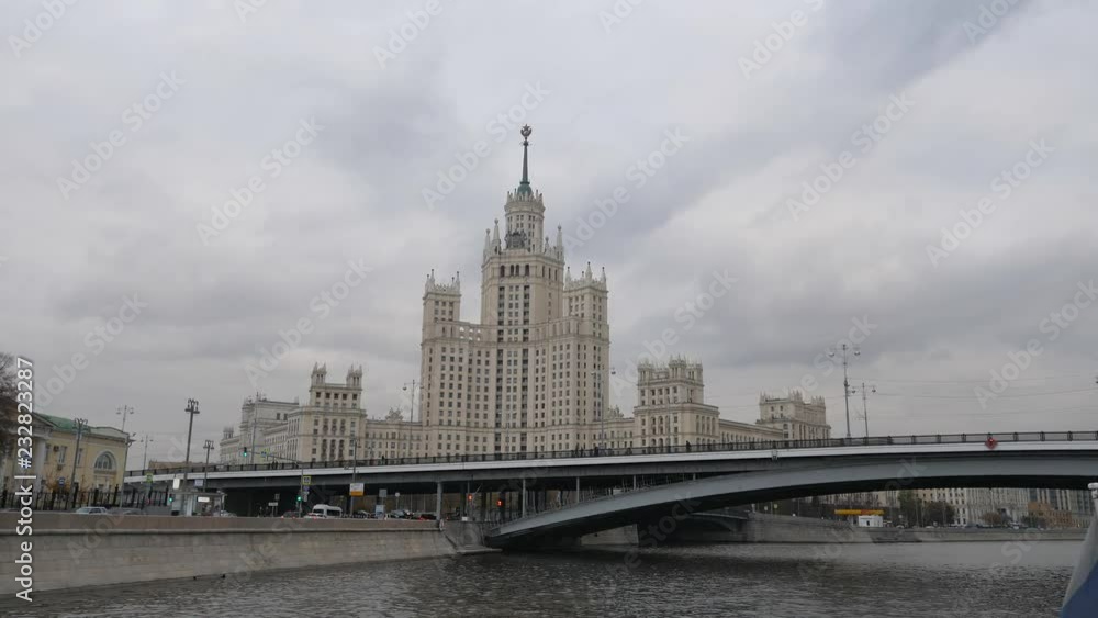 Stalin Vysotka on Kotelnicheskaya embankment view from Moscow river. Late autumn in the capital's quays. Navigable walking river. Stalin Vysotka on Kotelnicheskaya embankment view from Moscow river. Late autumn in the capital's quays. Navigable walking river.