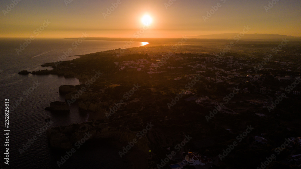 Aerial view of sunset over the coast Algarve, Portugal. Concept for above beach of Portugal. Summer vacations