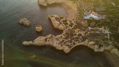 Aerial view of sunset over the coast Algarve coast, Portugal. Concept for above beach of Portugal. Summer vacations