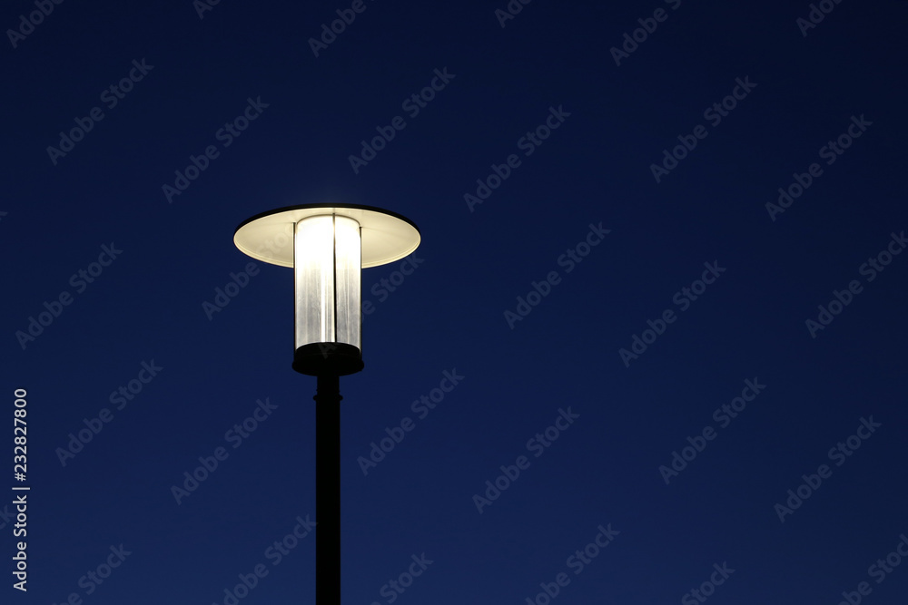 Glowing street lamp isolated on clear night sky background. Electric lighting, lantern shines Glowing street lamp isolated on clear night sky background. Electric lighting, lantern shines