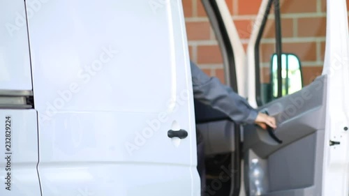 Delivery man riding on a truck to ship goods