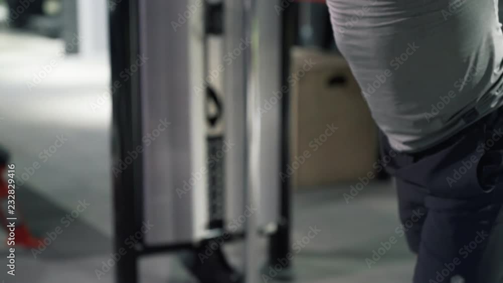 Close up athlete at the gym doing exercises on the muscles of the chest and shoulders Close up athlete at the gym doing exercises on the muscles of the chest and shoulders