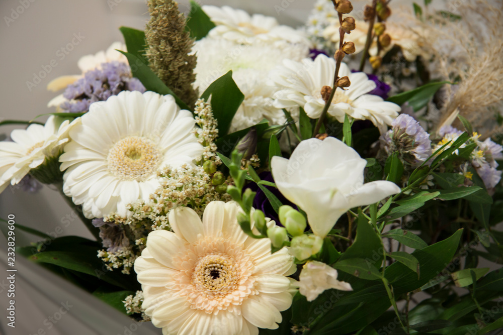 Romantic decorative beautiful background. Gerbera flowers, white and purple buds. Bouquet for a gift for a wedding or holiday Romantic decorative beautiful background. Gerbera flowers, white and purple buds. Bouquet for a gift for a wedding or holiday