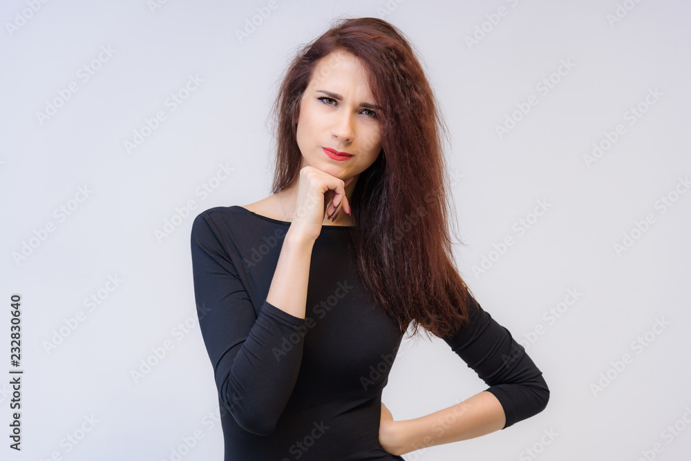 Studio portrait concept of a smiling beautiful brunette girl talking on a white background. Studio portrait concept of a smiling beautiful brunette girl talking on a white background.