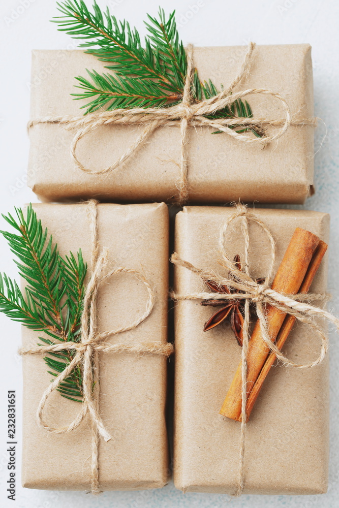 Christmas composition. Christmas gift, pine cones, fir branches on stone white background. Flat lay, top view Christmas composition. Christmas gift, pine cones, fir branches on stone white background. Flat lay, top view