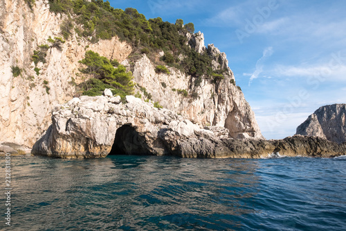 Caves in the cliffs on the island of Capri in the Bay of Naples, Italy. Photographed whilst on a boat trip around the island.