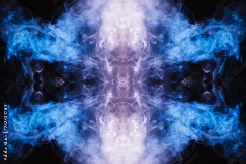 Abstract thick colored smoke on a black background with a monster face. The concept of light laser show at a musical concert and a print on a T-shirt Abstract thick colored smoke on a black background with a monster face. The concept of light laser show at a musical concert and a print on a T-shirt