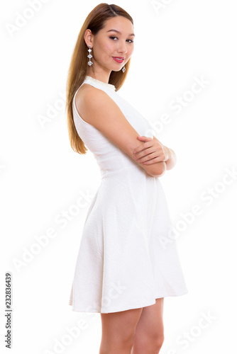Studio shot of young beautiful Asian woman standing with arms cr © Ranta Images