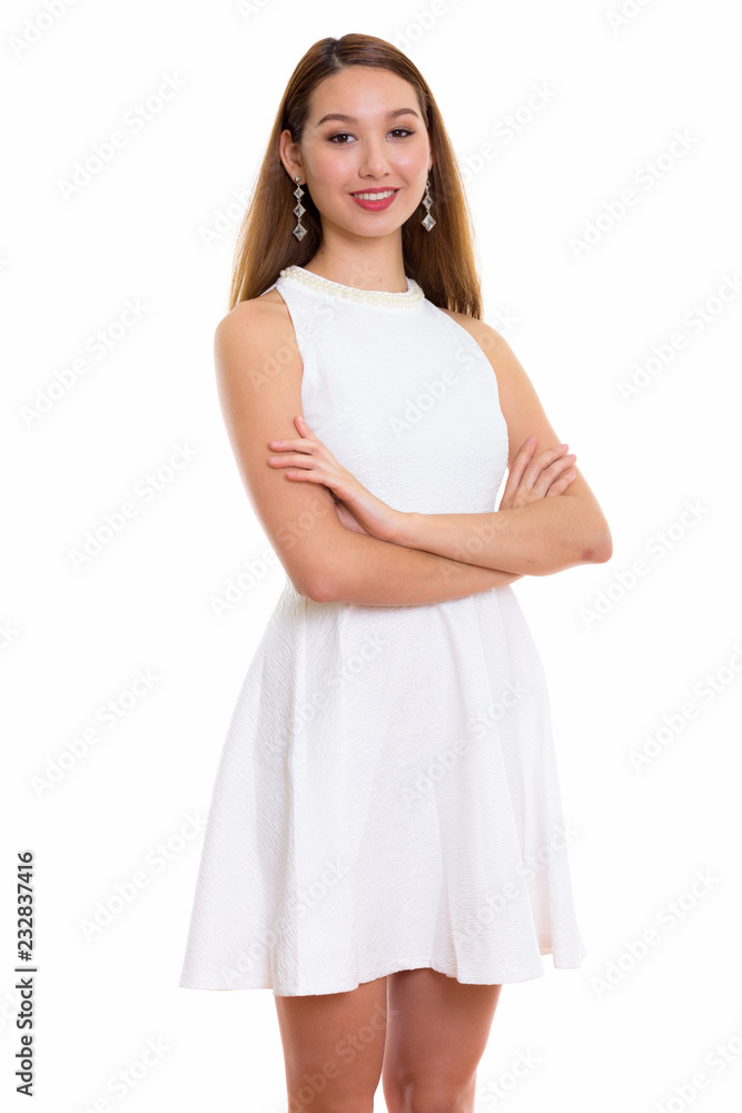 Studio shot of young happy beautiful Asian woman smiling and sta Studio shot of young happy beautiful Asian woman smiling and sta