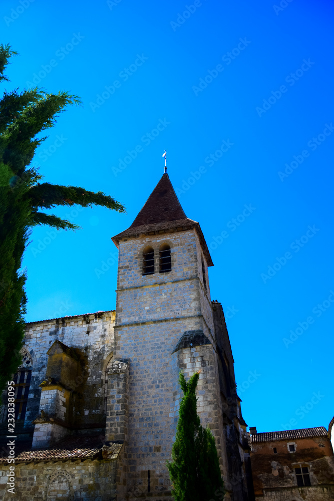 The spire of Eglise Saint-Dominique in the medieval bastide village of Monpazier in the Dordogne region of France