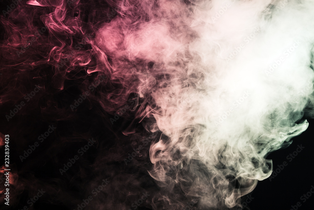 Colored smoke on a black background. The concept of light show at a music concert Colored smoke on a black background. The concept of light show at a music concert