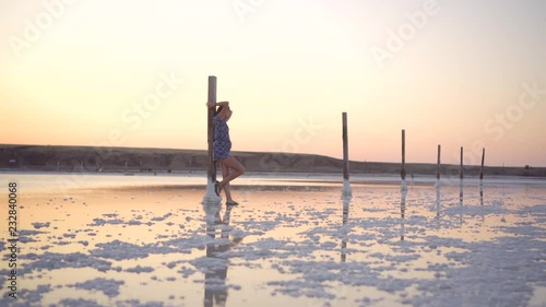 Wallpaper Mural Calm girl enjoying sun, walking slowly through the water of a salt lake Torontodigital.ca