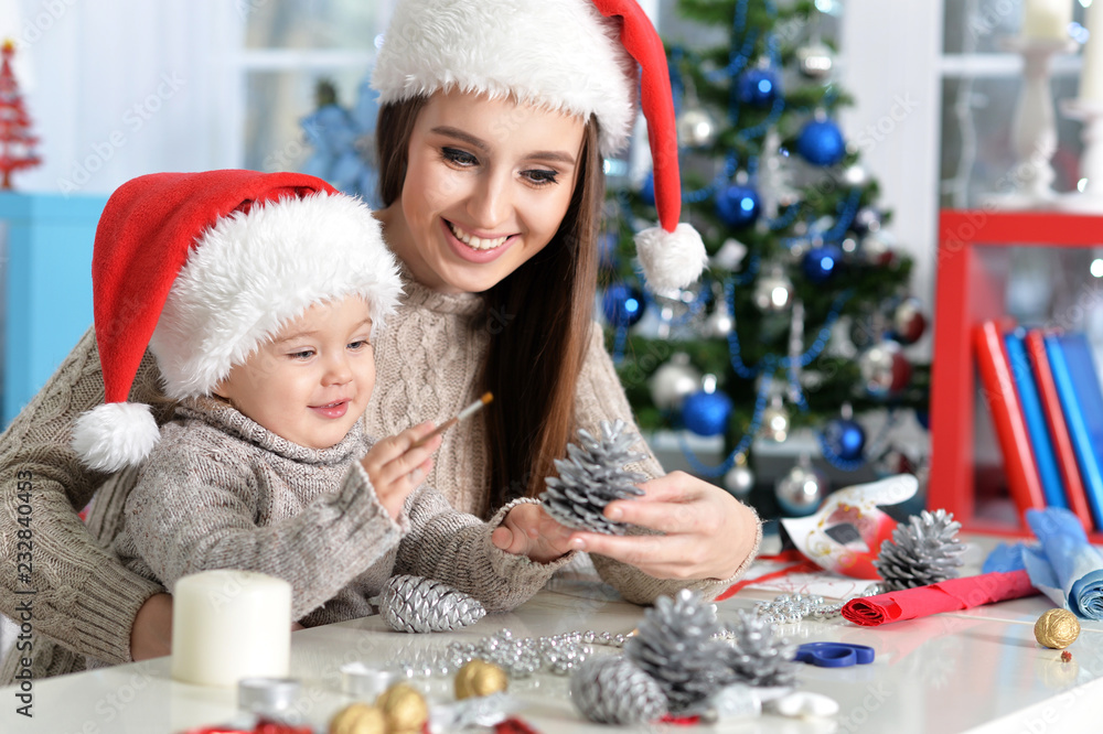 Portrait of smiling mother and daughter preparing for Christmas Portrait of smiling mother and daughter preparing for Christmas