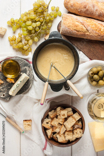 Dipping into a delicious cheese fondue made with a blend of assorted melted cheeses and wine