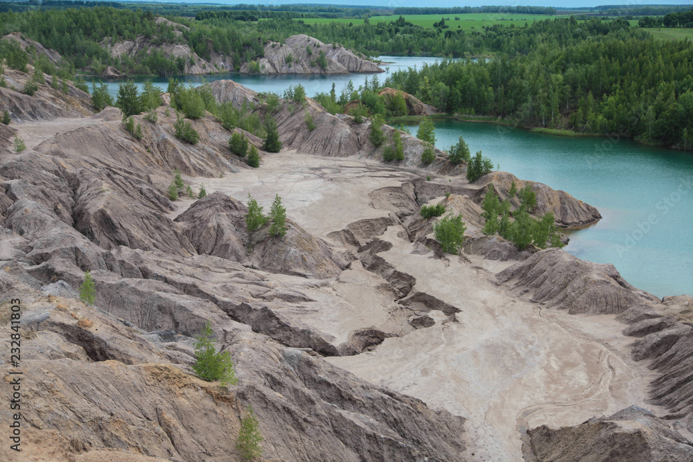 Beautiful blue lake and grren trees in closed sand quarry.