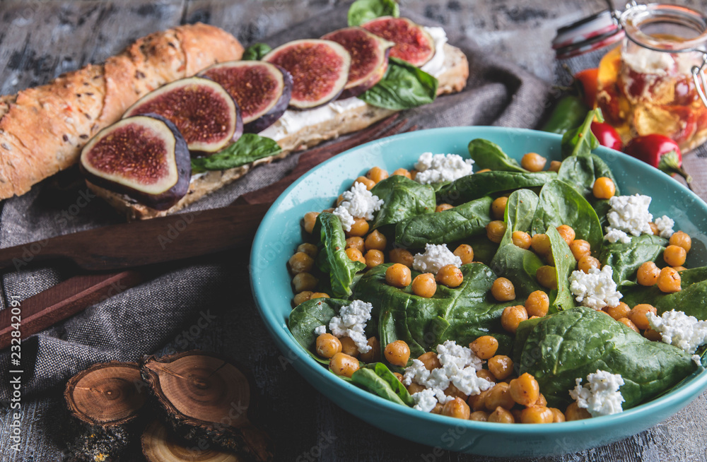 Fototapeta premium Chickpeas and veggies salad with spinach leaves, homemade cottage cheese.Healthy vegan food,sandwich with figs, diet dish