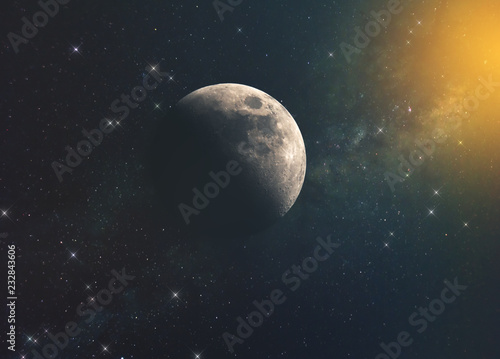 the moon against the milky way and the rays of the sun in the infinite space of the universe