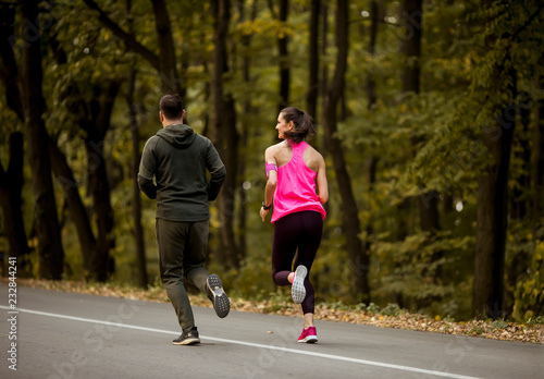 Athletic couple running tog...