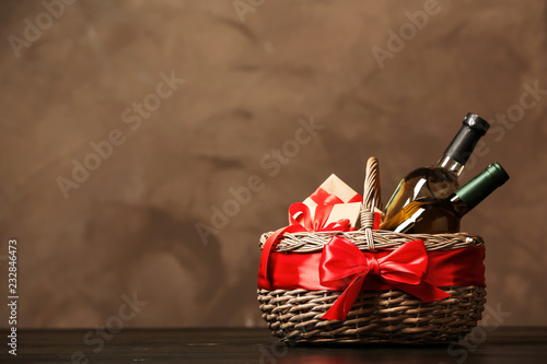 Gift basket with bottles of wine on dark background. Space for text