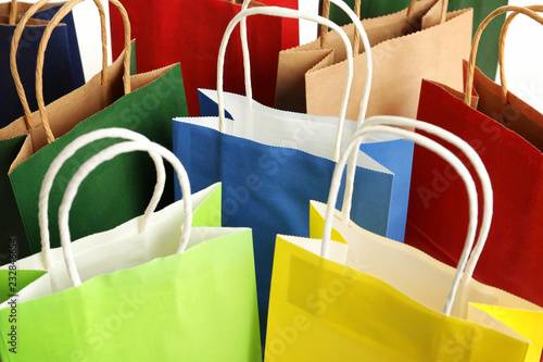 Colorful paper shopping bags as background, closeup