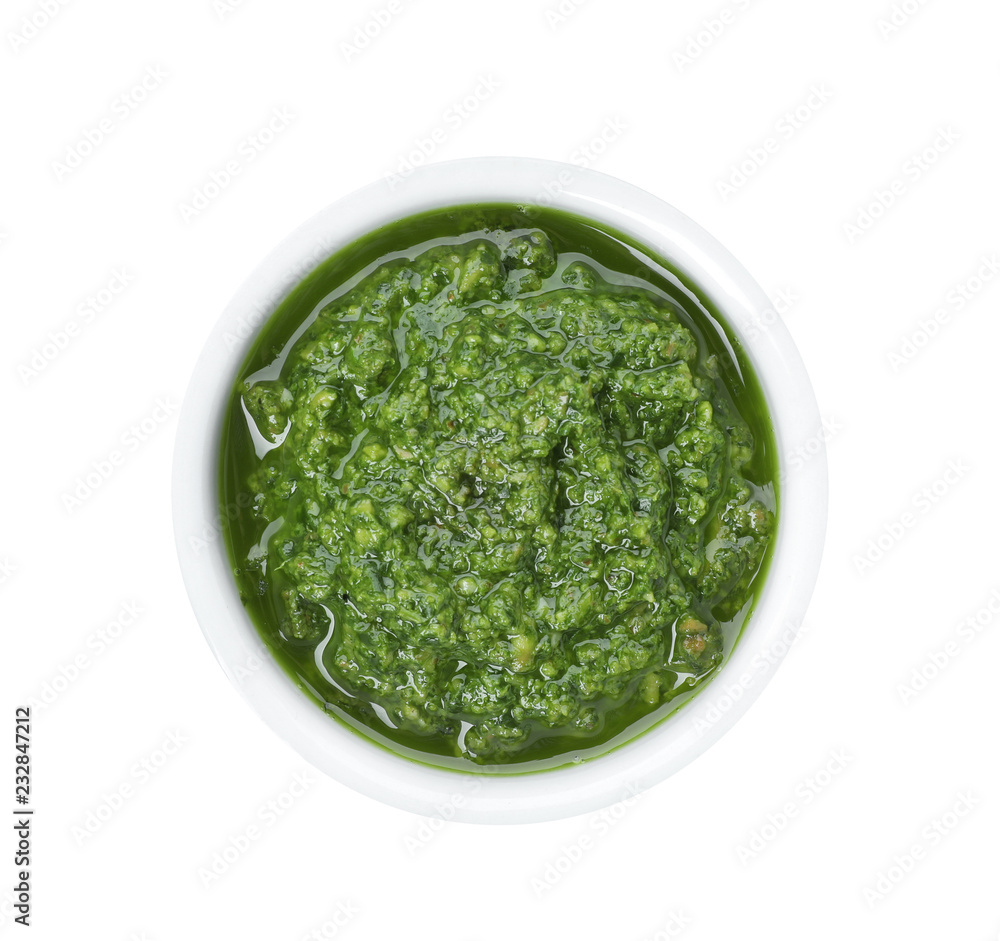 Homemade basil pesto sauce in bowl on white background Homemade basil pesto sauce in bowl on white background