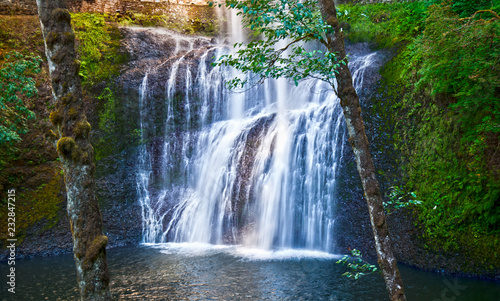 Waterfall with dancing fairy lights in enchanted forest/Glowing fairy lights around enchanted waterfall in forest