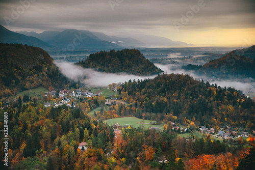 Rainy autumn landscape in hills. Sunrise light in background. Bled  Slovenia.