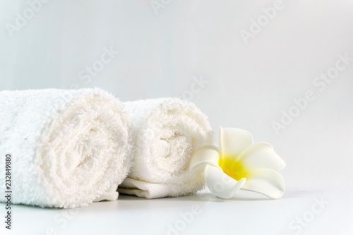 Pile of clean cotton bath towels on concrete background, laundry or bathroom concept