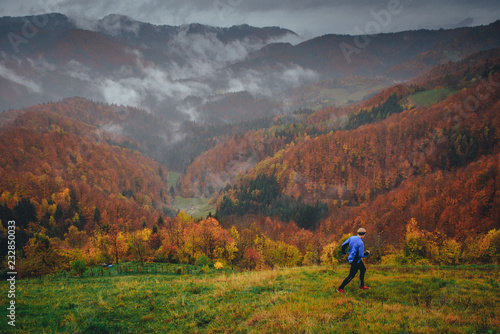 Athlete trail run in rainy autumn carpathian forest © kovop58