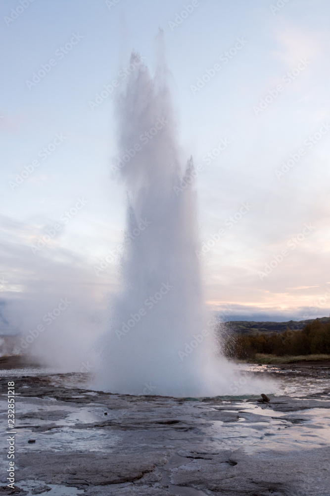 eruption of geyser Strokkur during dusk, Iceland