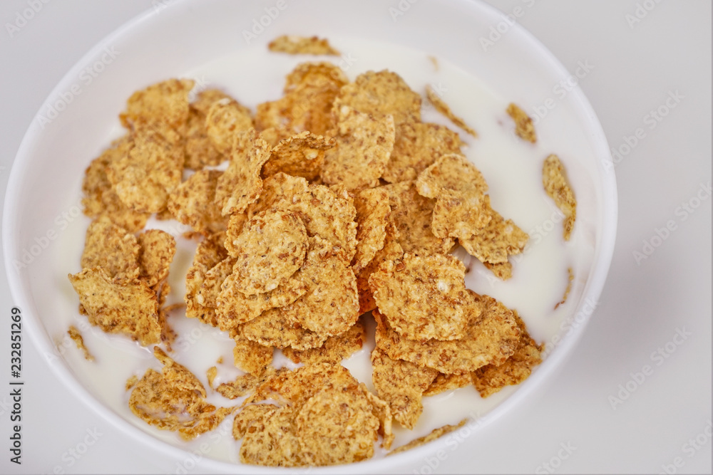 Cornflakes with milk on a white background Cornflakes with milk on a white background