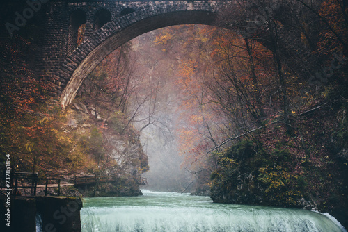 Autumn landscape.The famous Vintgar gorge canyon with wooden pats, beauty of nature, with river Radovna flowing through it, and the old bridge ,near Bled,Triglav,Slovenia,Europe