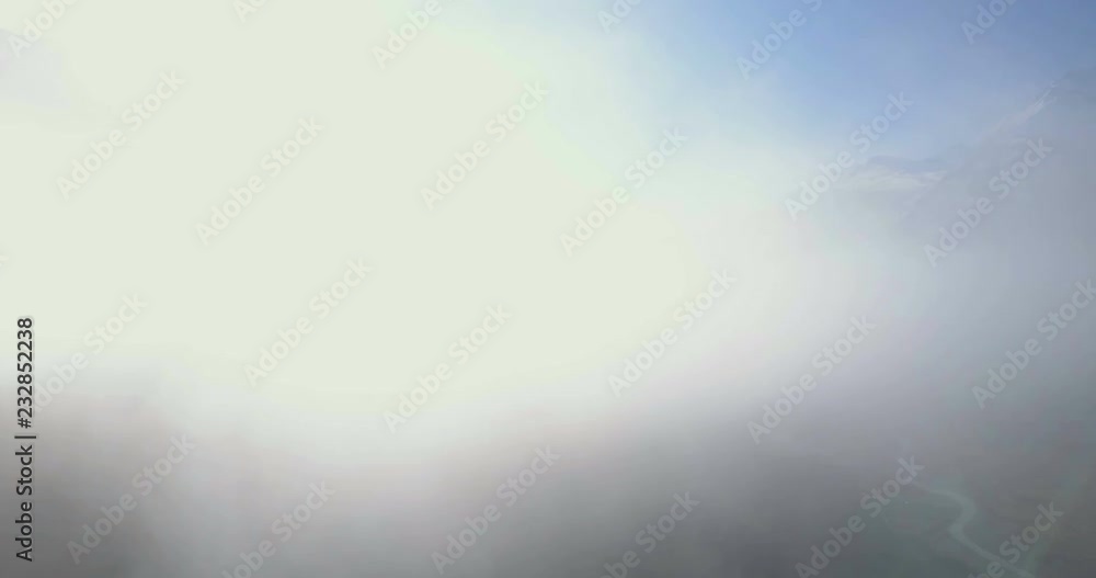 High key drone aerial landscape panning left to right through clouds to reveal snow-capped Himalayan mountain range and high altitude Manang valley in Nepal. 4k 1.9:1 23.976fps High key drone aerial landscape panning left to right through clouds to reveal snow-capped Himalayan mountain range and high altitude Manang valley in Nepal. 4k 1.9:1 23.976fps