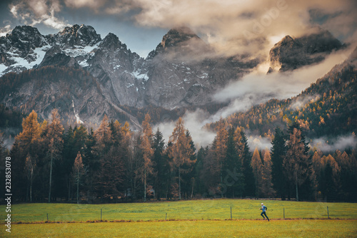 Fototapeta Naklejka Na Ścianę i Meble -  Athlete run in autumn mountains landscape